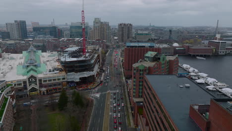 Forwards-fly-above-heavy-traffic-in-town.-Stream-of-cars-slowly-moving-on-multiple-road-in-urban-neighbourhood-on-cloudy-day.-Boston,-USA