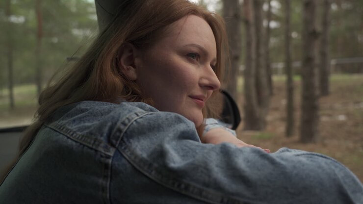 Red Haired Female Enjoys A Drive Through The Countryside From The Window Of The Car 2