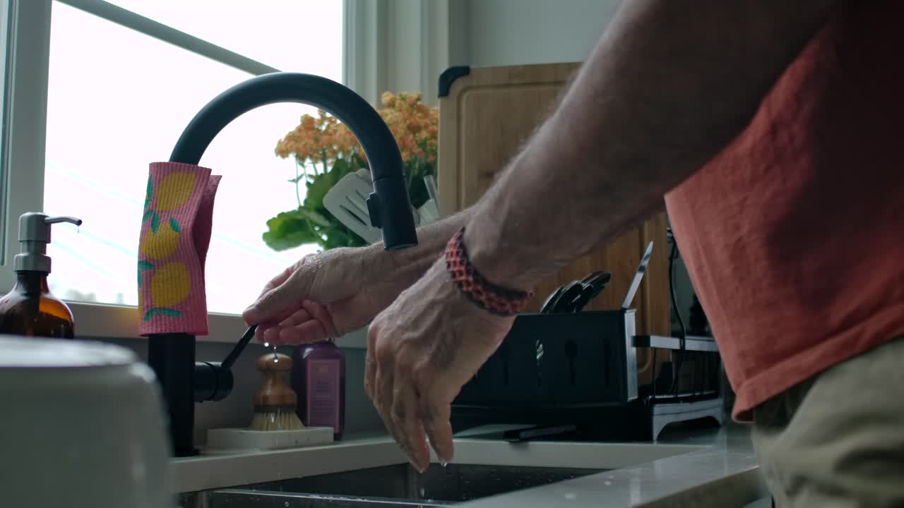 Adult Man Washing Hands at Kitchen Sink - Static Slow Motion