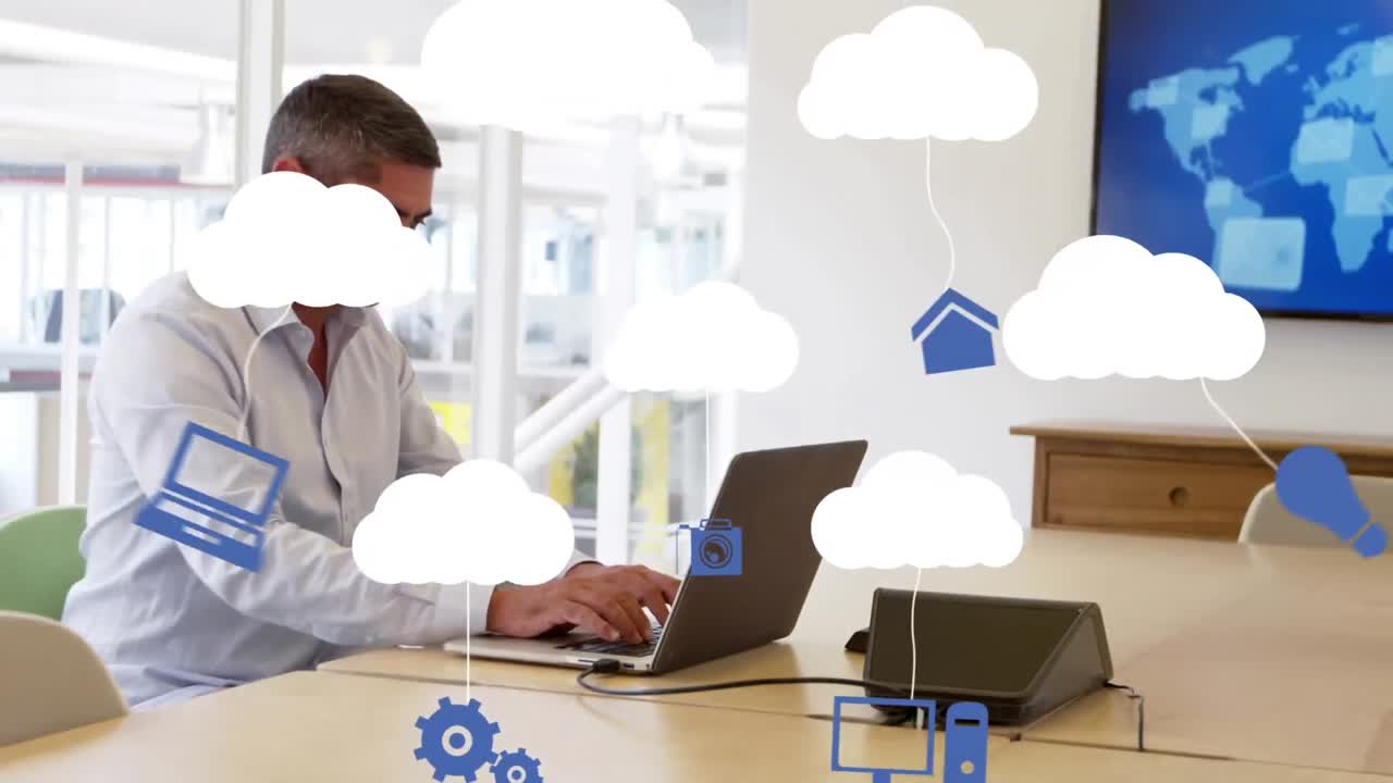 animación de una red de iconos digitales sobre un hombre de negocios usando una computadora portátil