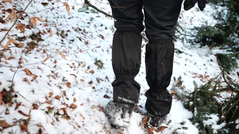 a hiker walking on a snowy mountain, romania, sinaia