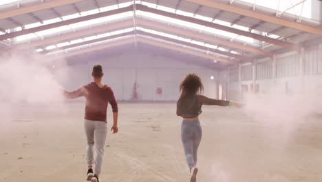 bailarines en un almacén vacío con una granada de humo