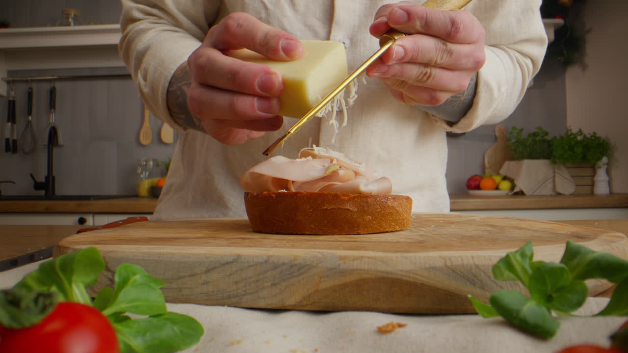 Making a gourmet sandwich with ham and cheese