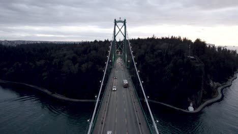 car traffic along lions gate bridge at dusk, vancouver in canada