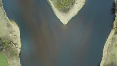 aerial top footage, countryside spring panorama of small island in quiet river on sunny evening day