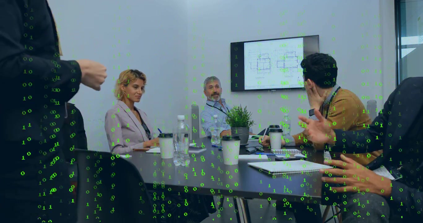Presenter pointing at screen, team taking notes and reviewing architecture plans with green overlay