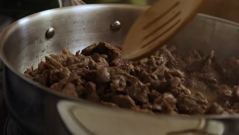 homemade beef carne flavoured taco meat cooking in frying pan, closeup