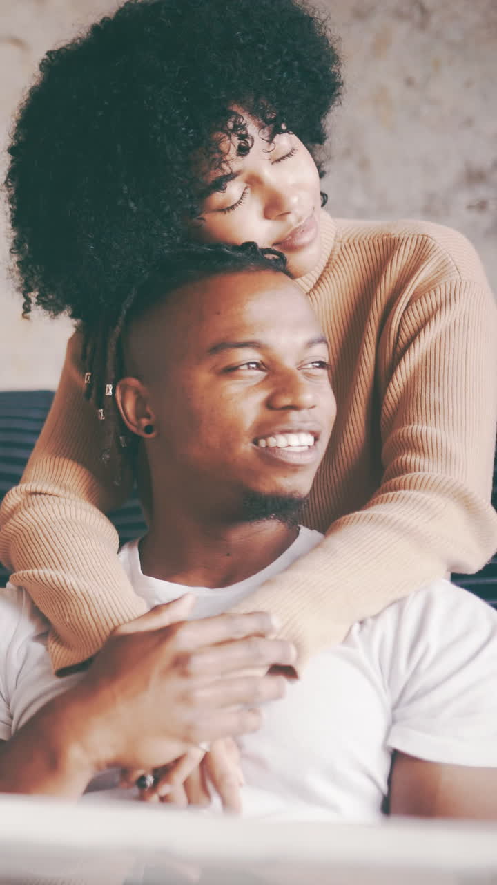 Happy Young Black Couple Embracing and Smiling at Home