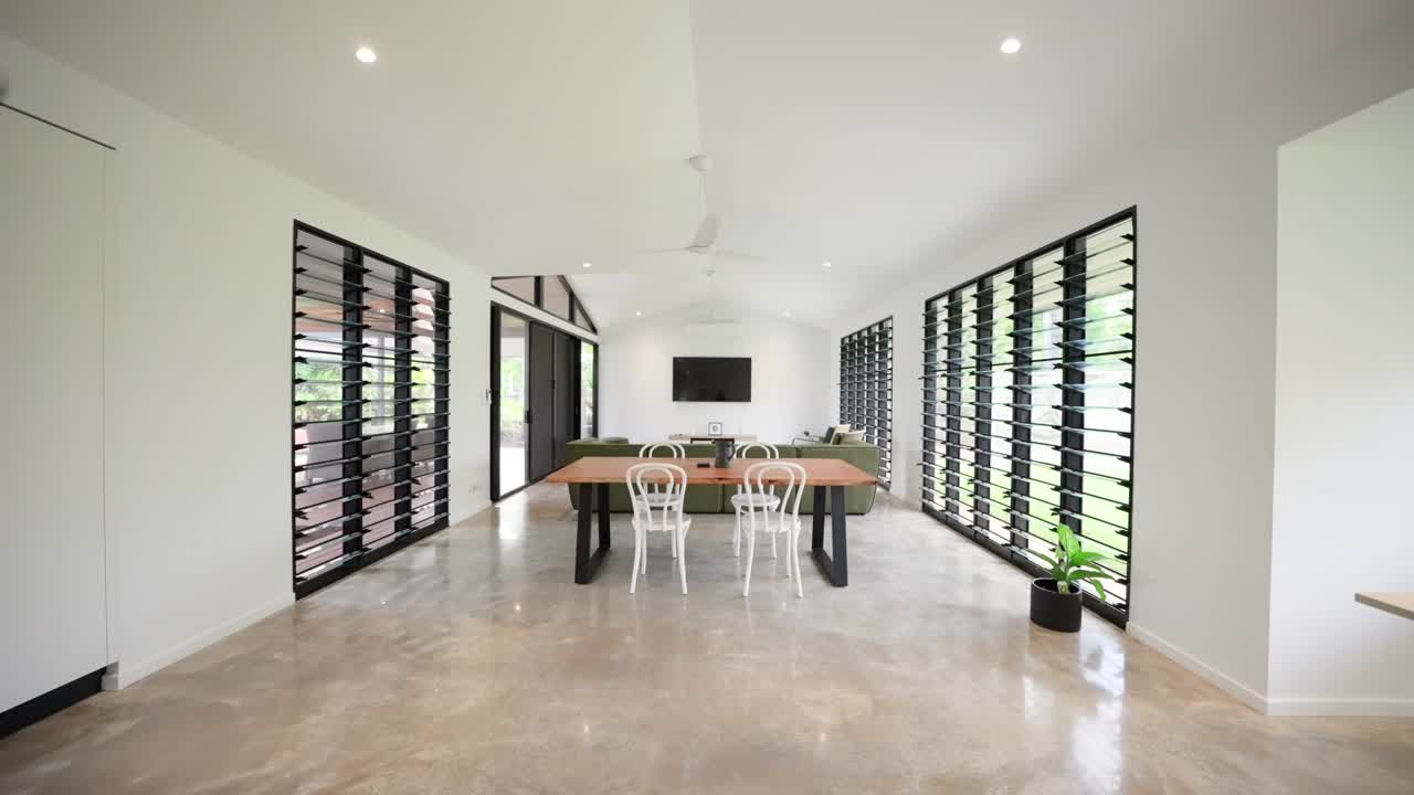 Contemporary open-plan tropical home interior with clean lines, open space, and modern furnishings in a staged