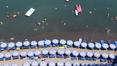 people swimming and relaxing by the sea