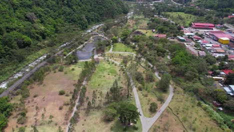 boquete, panama. drone shot of park, river, green hills and buildings in valley