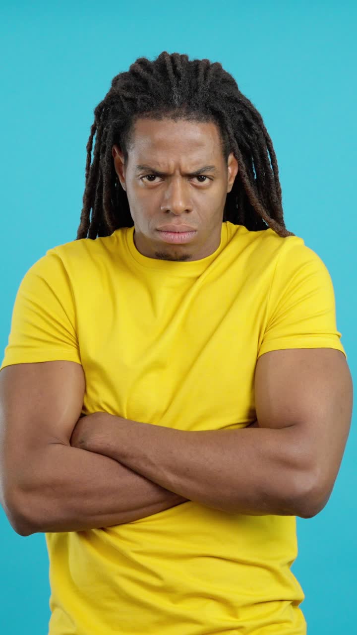 Man with dreadlocks and arms crossed