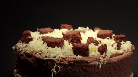 close up detail shot brownie and cheese cake delicious treat tasty sweet in a turn table black background