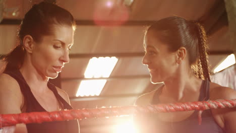 female boxers interacting with each other in boxing ring