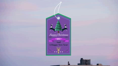 animation of christmas greetings on tag over cityscape in background