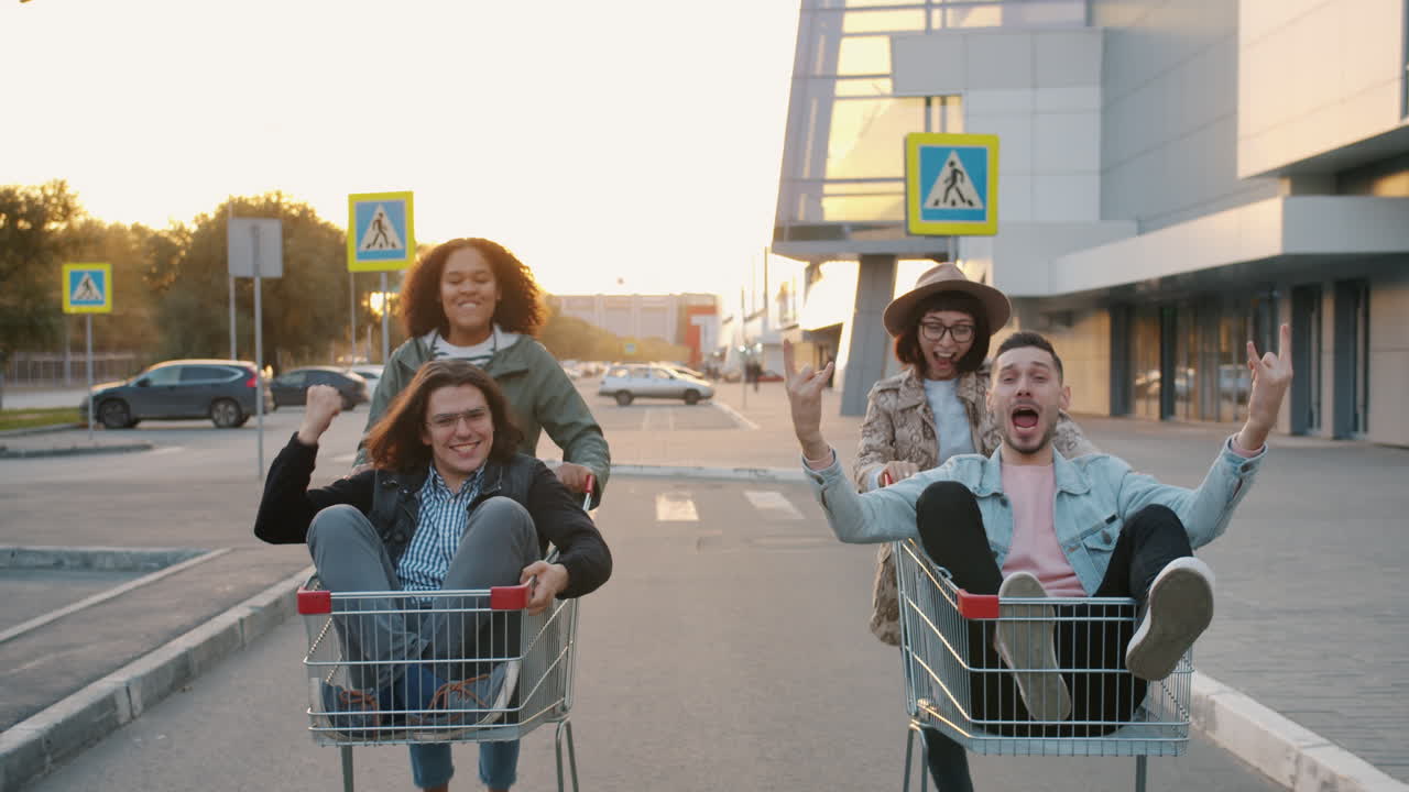 Friends Having Fun Riding Shopping Carts