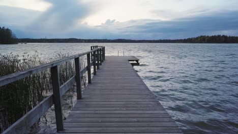 un muelle de madera vacío en un lago en una ventosa noche de otoño