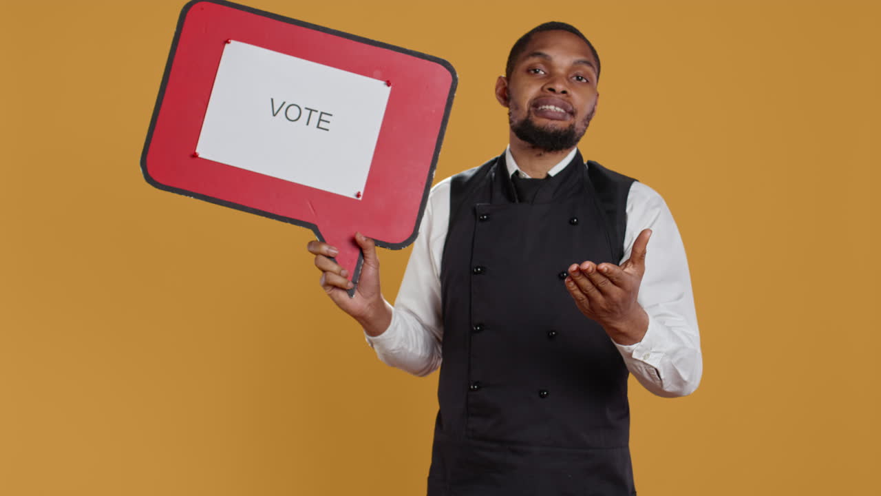 Professional waiter showing a message to vote on speech bubble