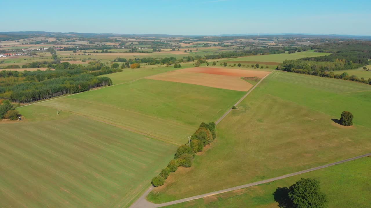 flying over green landscape on a sunny day