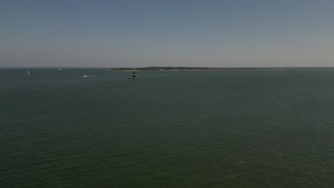 An-aerial-view-the-Orient-Point-lighthouse-off-the-east-end-of-Orient-Point,-NY-on-a-sunny-day