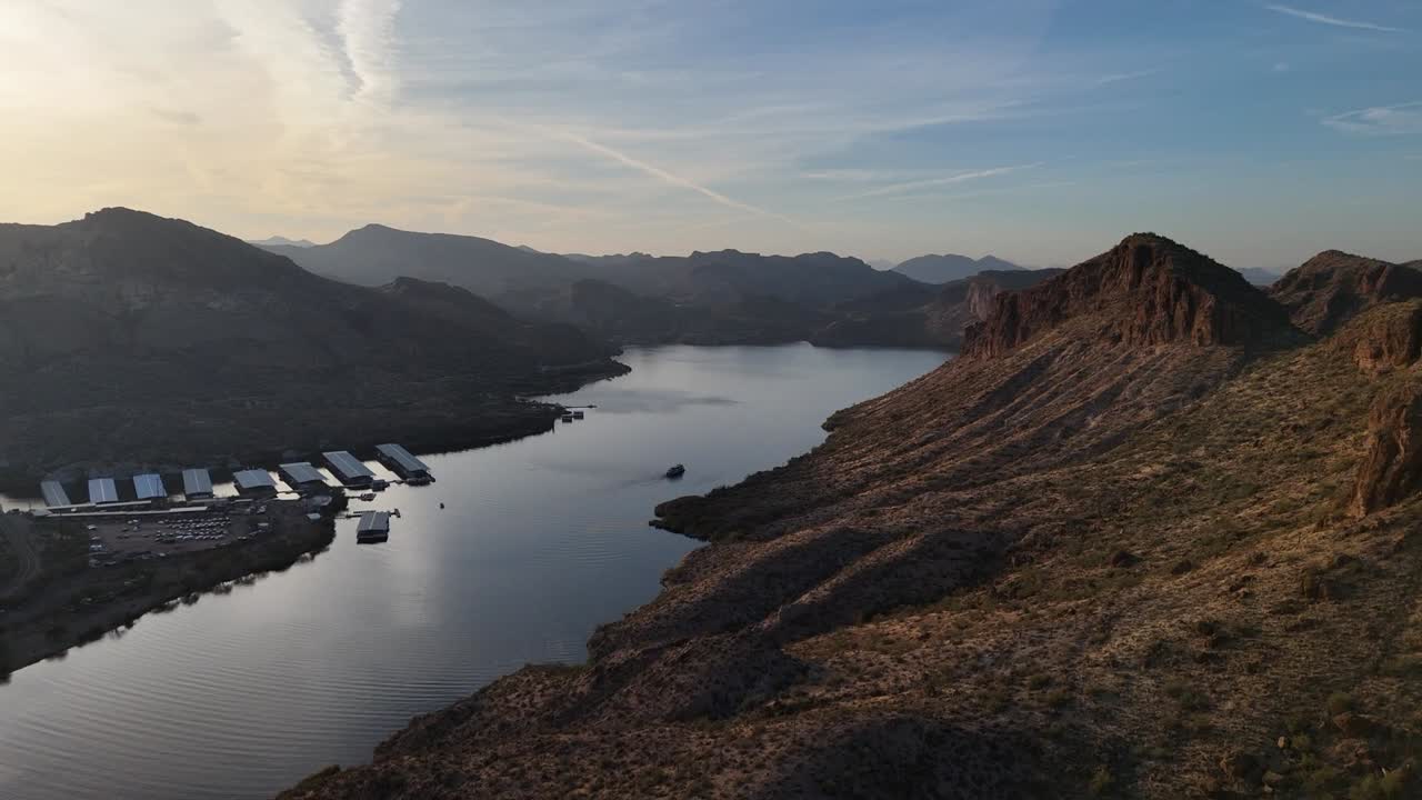 Drone View of Canyon Lake on the Apache Trail in Arizona. Late evening with cruise boat on the water with High rising mountains