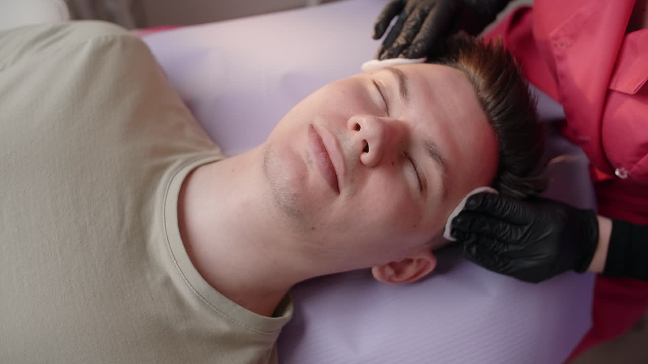 Man receiving a facial treatment