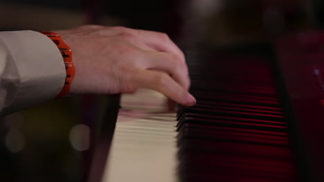Closeup of hands playing piano at event in slow motion