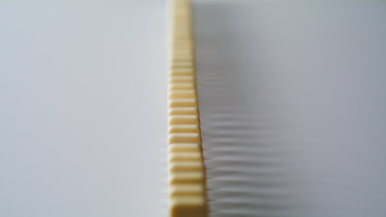 Domino bricks arranged row on white table surface closeup. Toy blocks pattern