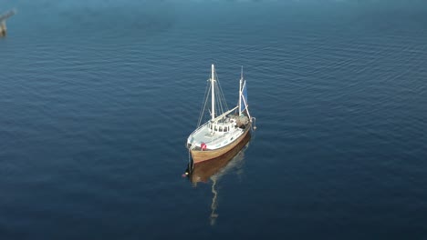 A-sailboat-moored-in-the-fjord-near-the-Steinvikholm-castle,-Trondelag,-Norway