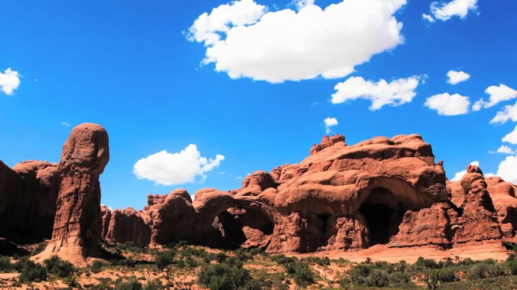 A red sandstone monument in the desert  time lapse 3