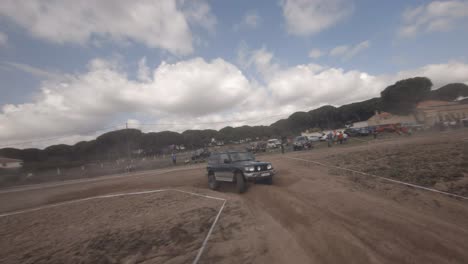 dynamic fpv flight follows mitsubishi off road truck in dusty race