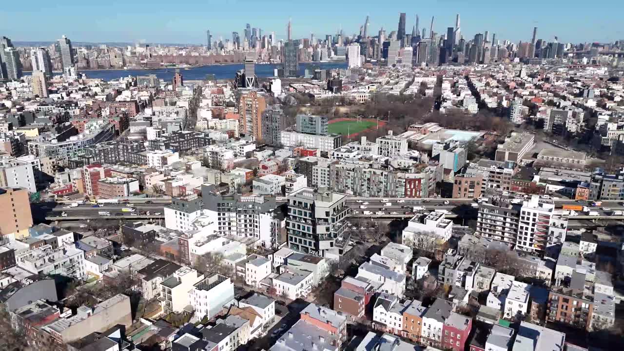Horizontal drone circular shot over Withers Street in Brooklyn, capturing the city's vibrant streets, historic architecture, and dynamic urban landscape with smooth aerial motion.