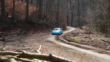 the valasska rally and the porsche race car coming out of a bend into a short section between tree trunks will pass part of the circuit in the middle of the forest road captured in 120fps slow motion.