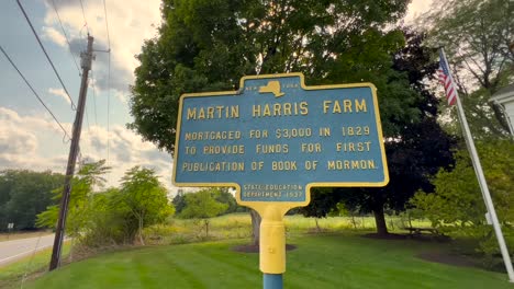 slow push in on a sign to the martin harris farm of downtown palmyra new york