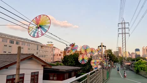 pinwheels rotate above urban walkway