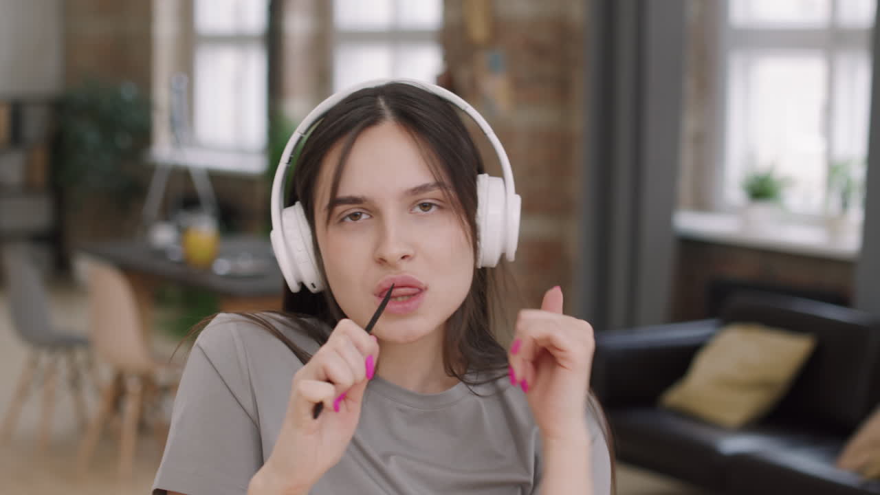 Portrait of Woman in Headphones Singing and Dancing