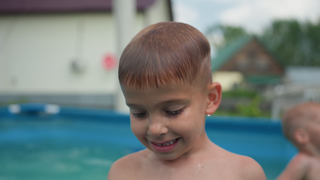 Youthful Boy Smiling, Child With Wet Hair By Poolside Smiling, Young Child With Damp Hair Showing Gentle Smile Near Water, Shy Young Boy With Wet Hair Gazing Thoughtfully Beside Tranquil Pool