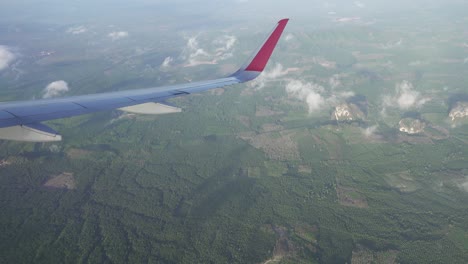 flying on airplane over krabi province, thailand