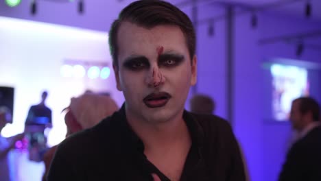 male with face paint looking up during carnival party, slowmo