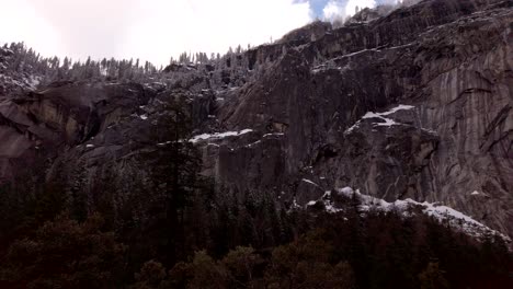 Slow-rotating-shot,-looking-up-at-the-sheer-granite-cliff-faces-on-the-Mist-trail-in-Yosemite-National-Park,-California