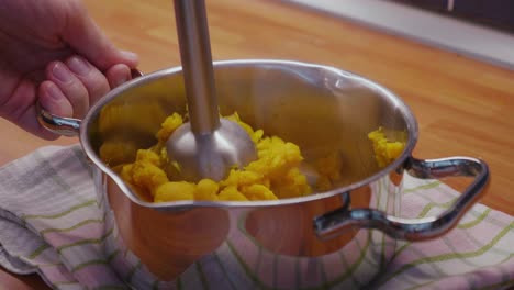 preparing healthy mashed sweet potato with coconut milk