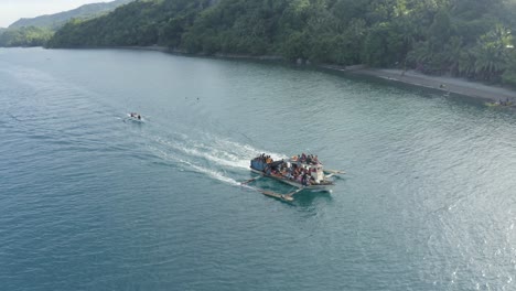 local fishermen riding on fishing boat sailing on a blue sea at tropical island in philippines