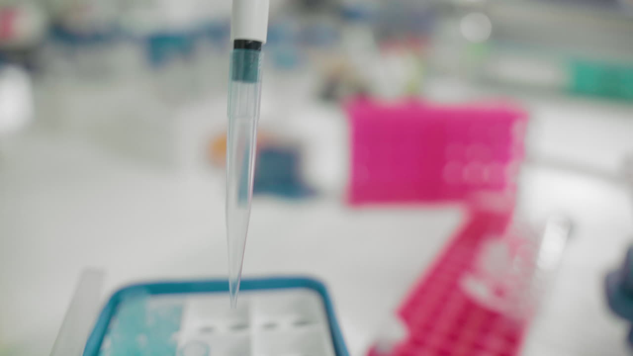 Scientist's hand holding pipette using DNA analysis for patient