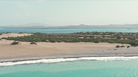 Aerial-view-over-waves-on-the-coast-of-Las-Dunas-De-Bani-in-Dominican-Republic