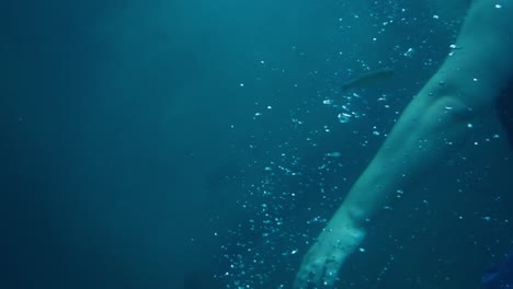 underwater view of a man swimming in mountain river