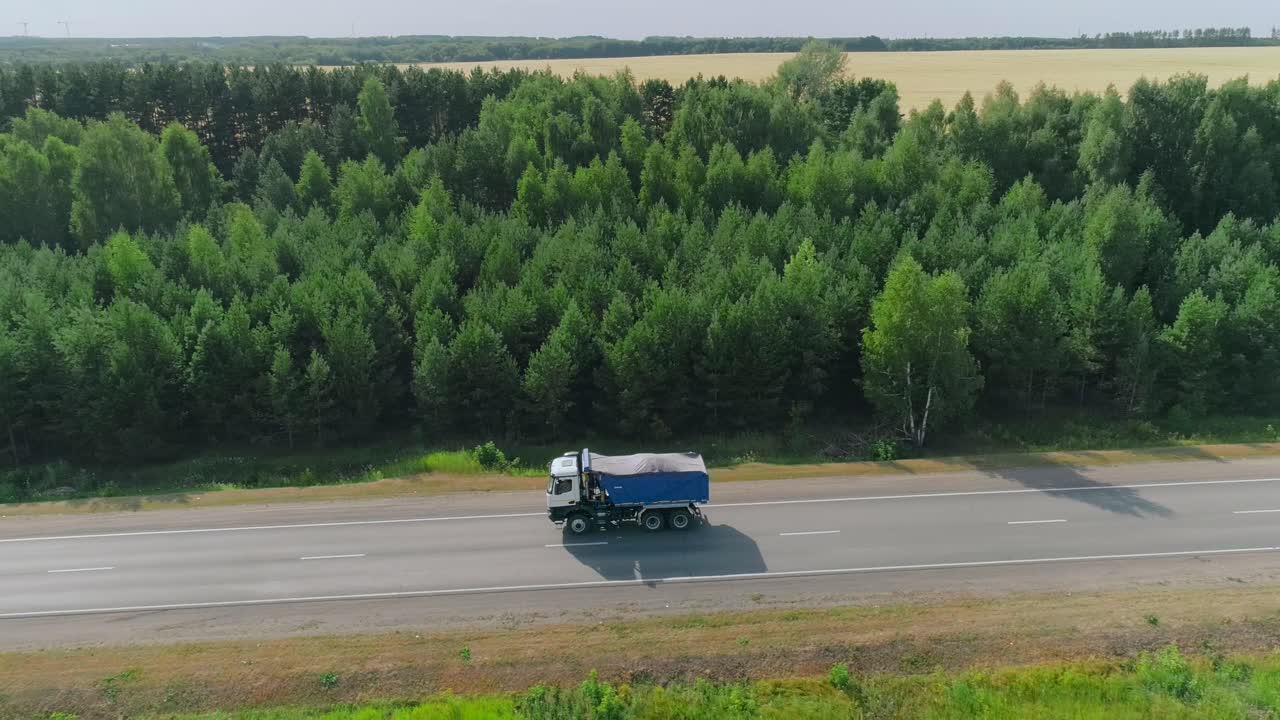 Truck on a Country Road Through a Forest