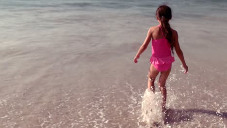 Cute-girl-running-towards-waves