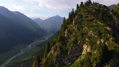 Epic-aerial-view-flying-over-a-ridge-to-reveal-a-vast-mountain-valley-in-Kyrgyzstan