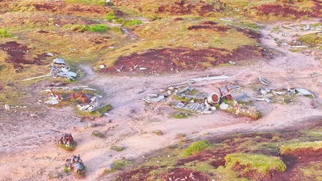 Drone approaching memorial B-29 Superfortress WWII plane wreckage site in the Peak District, England, with an American flag gently waving.