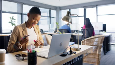 Portrait-of-african-american-businesswoman-using-laptop-in-office,-slow-motion,-copy-space